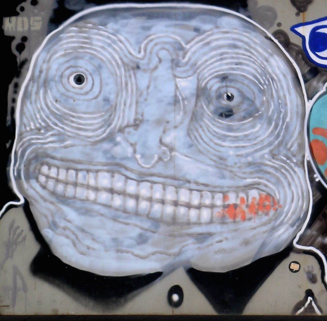 a graffiti from Born with a grinning psychedelic face
